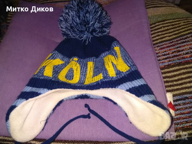 Зимна шапка с пискюл и вързанки на Кьолн, снимка 1 - Футбол - 39097529