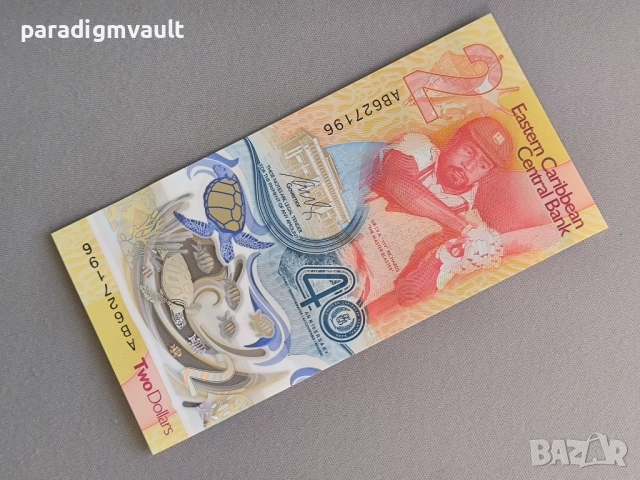 Банкнота - Източни Кариби - 2 долара (юбилейна) UNC | 2023г.