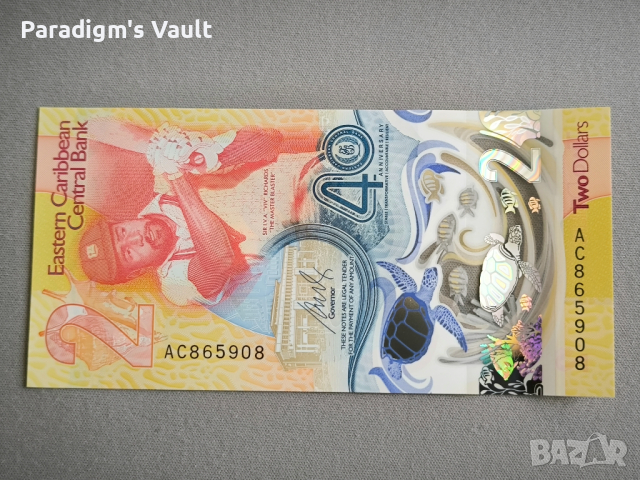 Банкнота - Източни Кариби - 2 долара (юбилейна) UNC | 2023г., снимка 2 - Нумизматика и бонистика - 44924004