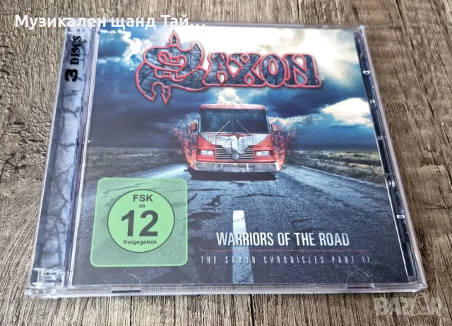 Компакт Дискове - Рок - Метъл: Saxon – Warriors Of The Road - Part II - 2 DVD + 1 CD