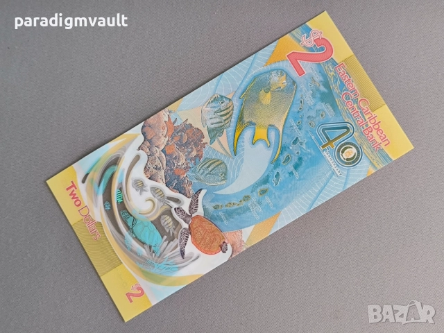 Банкнота - Източни Кариби - 2 долара (юбилейна) UNC | 2023г., снимка 2 - Нумизматика и бонистика - 52254665