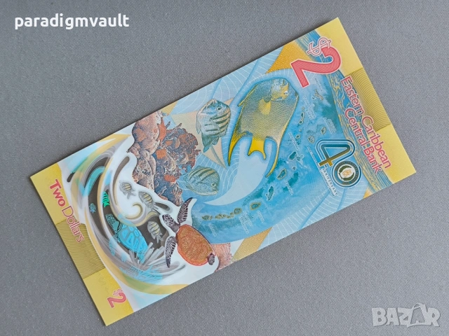 Банкнота - Източни Кариби - 2 долара (юбилейна) UNC | 2023г., снимка 2 - Нумизматика и бонистика - 53130733