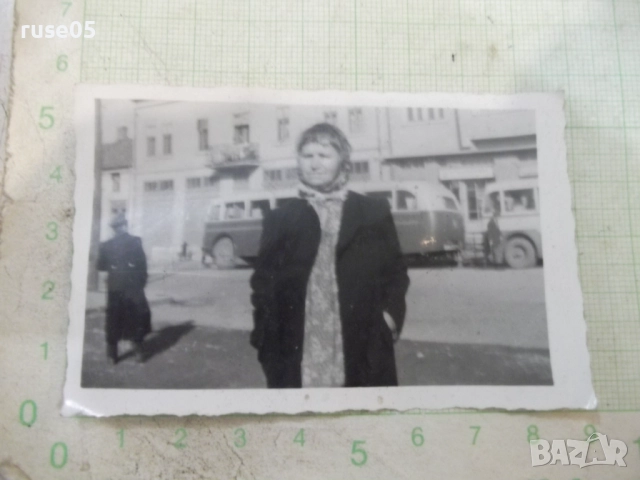 Снимка стара на жена пред автобусите